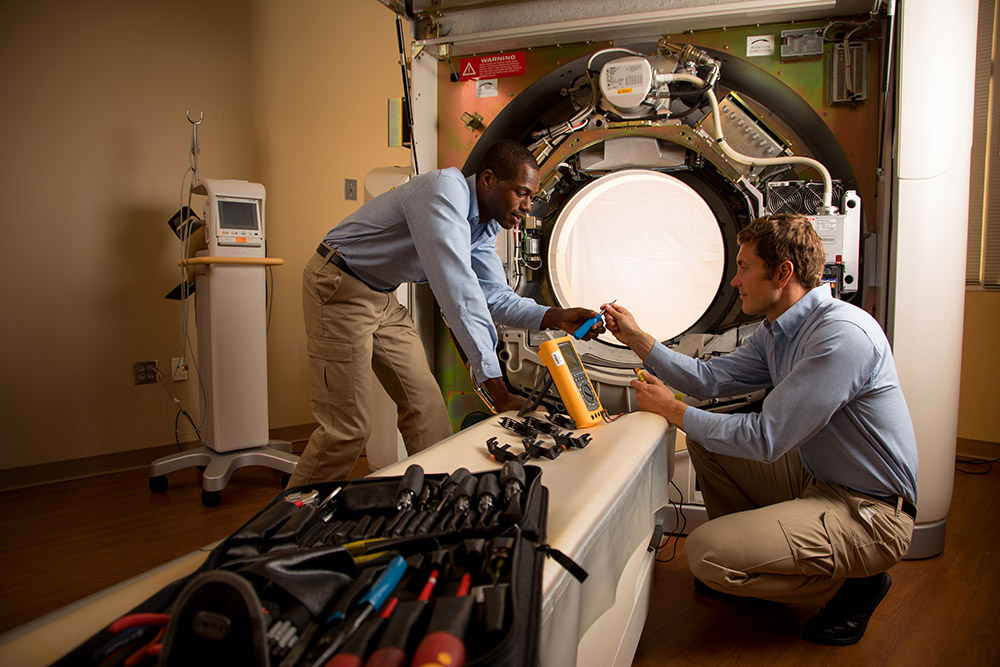 Intelas team repairing hospital equipment