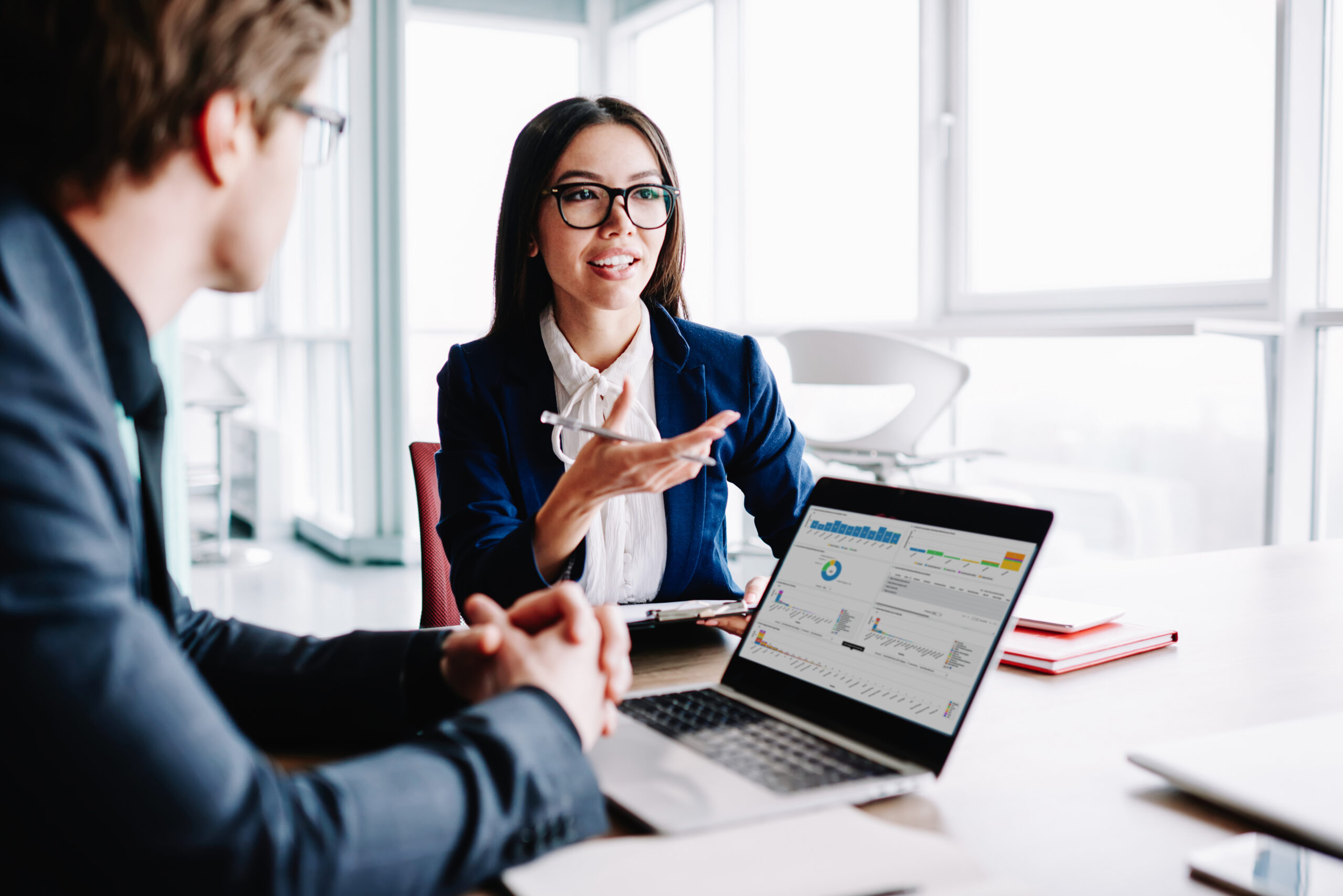 TeamCHAMPS younf female manager talking to colleague and smilng